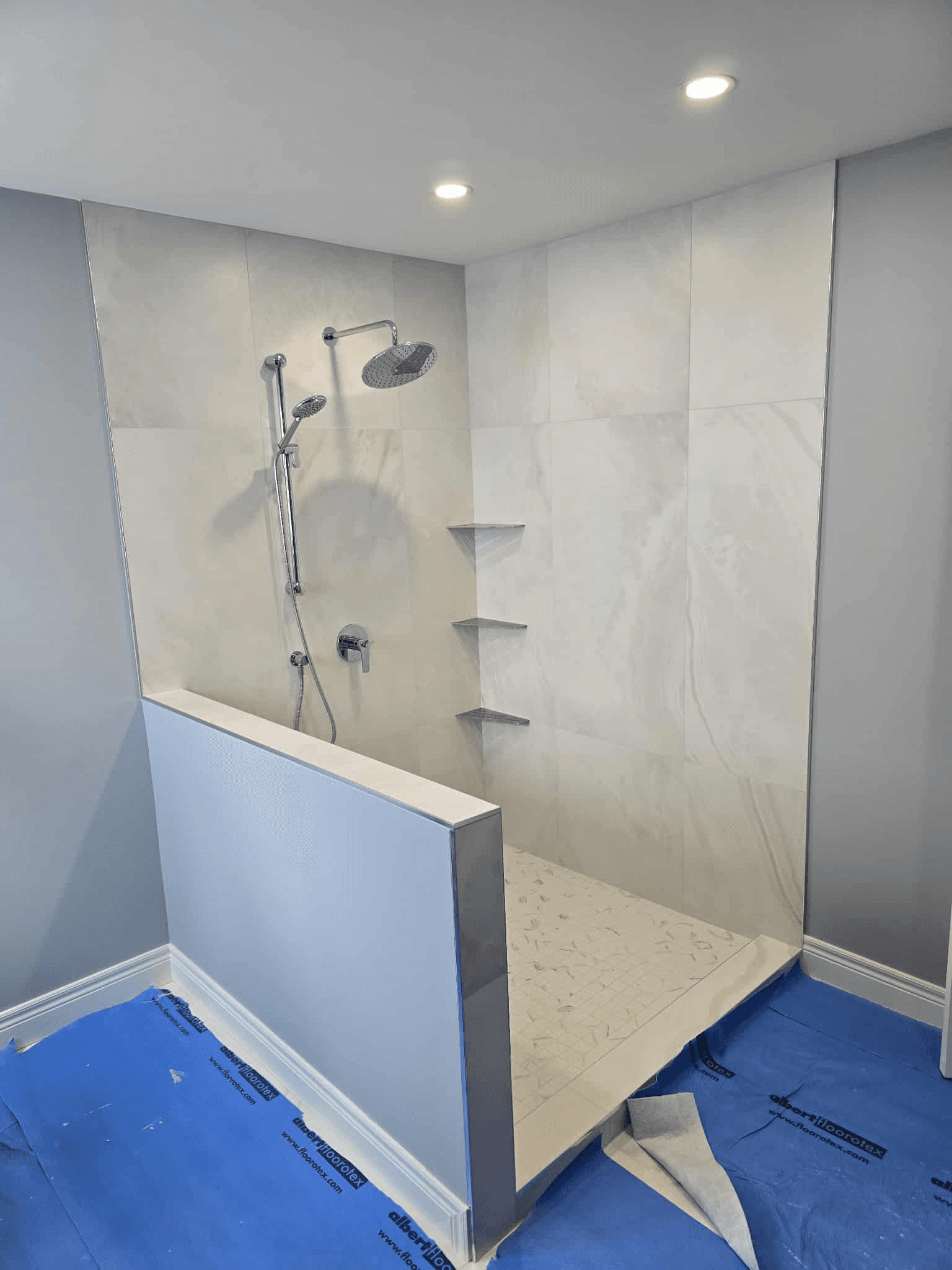 Glass shower with half wall